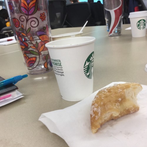 Coffee, water, and half a doughnut